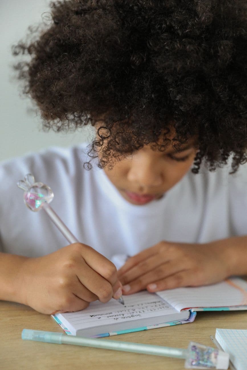 A child writing at a desk